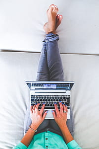 Woman lying and typing on laptop thumbnail