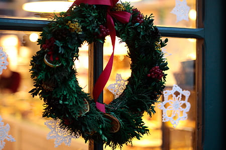 green wreath hanging on window thumbnail
