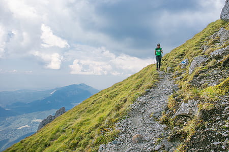 person walking on pathway during daytime thumbnail