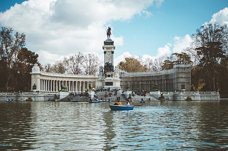 Boat in Water and Building With Statue thumbnail