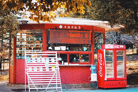 red Coca-Cola beverage cooler near store thumbnail