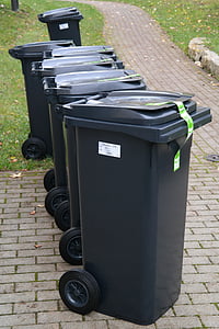 black garbage bins on concrete pathway thumbnail