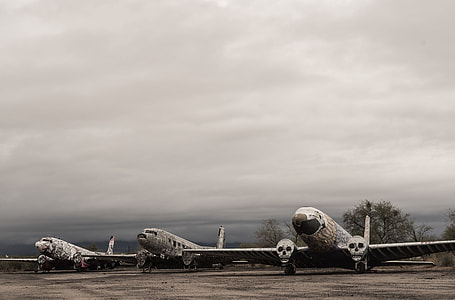 three white passenger planes under gray sky during daytime thumbnail
