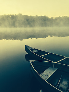 two black canoe on calm body of  water thumbnail