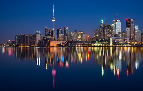 city buildings at night time with reflection on water thumbnail