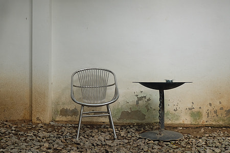 round black metal table beside gray metal chair thumbnail