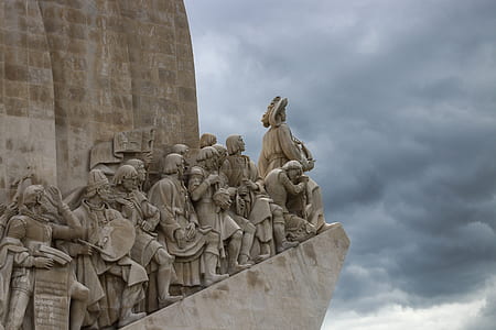 group of men standing beside wall statues thumbnail