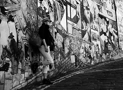 grayscale photography of woman leaning on wall thumbnail