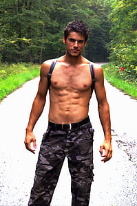 photograph of topless man in front of road thumbnail