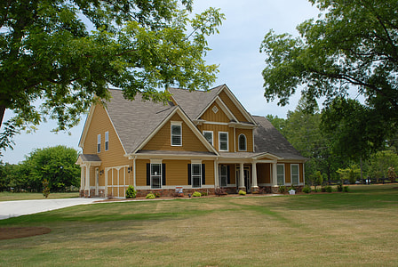 brown and white 2-storey house surrounded trees during daytime thumbnail