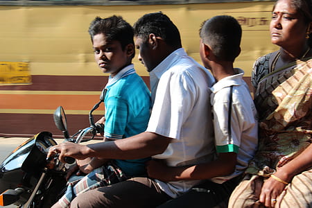three men's and one woman riding black standard motorcycle thumbnail