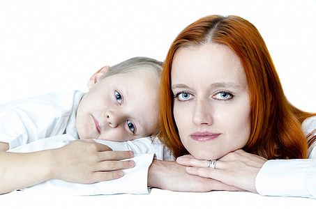 woman wearing white top and boy wearing white top leaning on white surface thumbnail