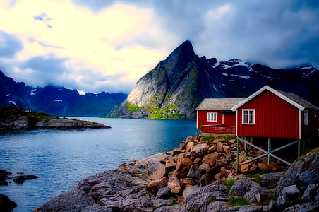 red barn near body of water thumbnail