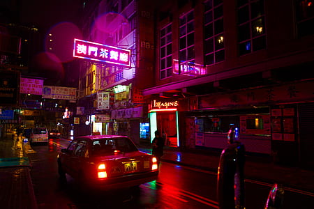 white sedan near building during night time thumbnail