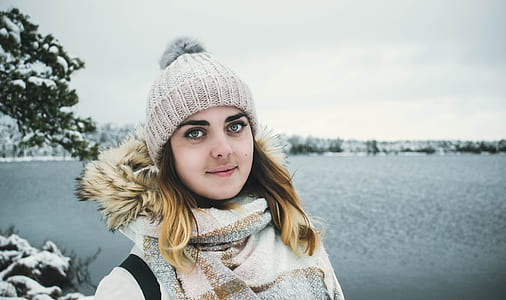 Woman Wearing White Bobble Hat and Jacket thumbnail
