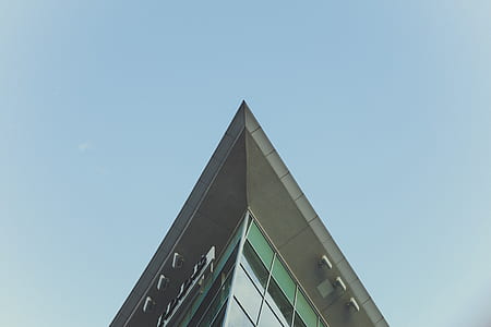 low angle view of gray building under blue sky thumbnail