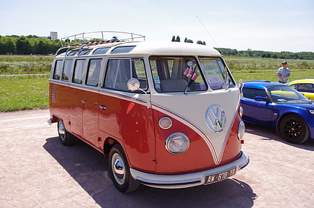 white and red Volkswagen Samba parked beside blue vehicle thumbnail