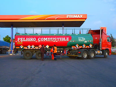 red and green Peligro Combustible truck beside Primax gas station during daytime thumbnail