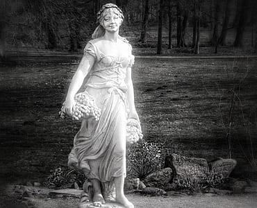 greyscale photo of woman holding fruits statue thumbnail