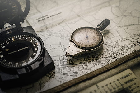 gray compass on top of map thumbnail