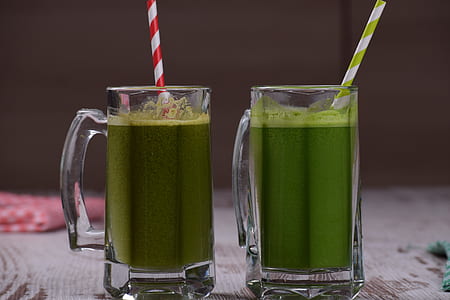 green liquid inside two clear glass mugs thumbnail