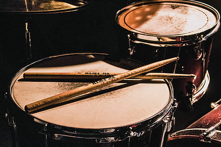two red snare drums with drum sticks thumbnail