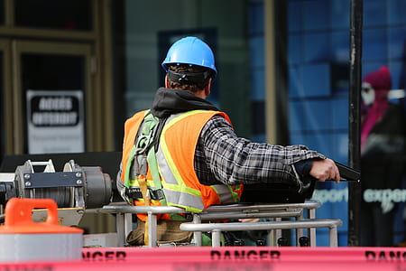 man wearing black and white plaid long-sleeved shirt and blue hard hat thumbnail