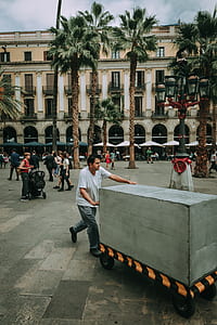 Man Pushing Gray Cart thumbnail