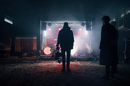 silhouette of man standing in front of stage thumbnail