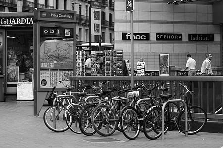 grayscale photo of bikes near handrails thumbnail
