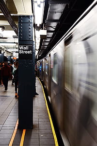 people on train station with wall street signage thumbnail