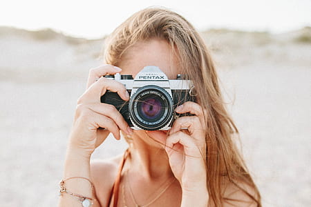 woman using Fujifilm Pentax DSLR camera thumbnail