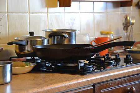 skillet on gas cooktop near bowls and plate thumbnail