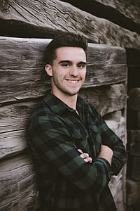 man smiling while leaning on wall thumbnail