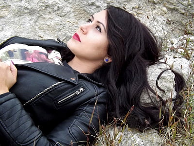 woman lying on rock wearing beside grasses thumbnail