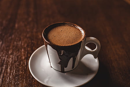 white and black mug with coffee on saucer thumbnail