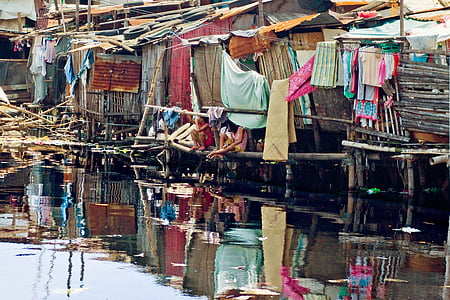 two kids sitting on wooden pole looking on body water thumbnail
