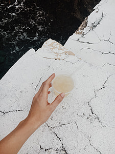 person holding plastic cup thumbnail