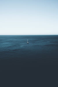 aerial photo of a boat sailing on sea during day time thumbnail