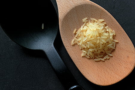 brown and black ladle of rice grains thumbnail