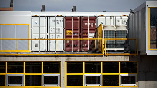 assorted-color intermodal containers on ground thumbnail