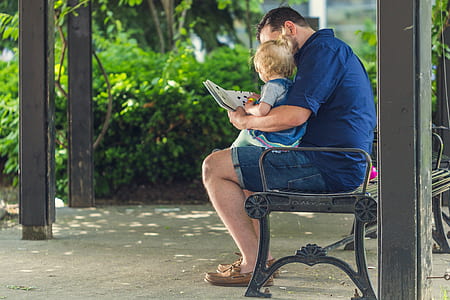 man and child reading book thumbnail