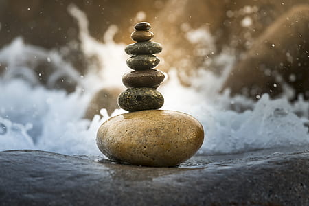 brown balance rock near body of water thumbnail
