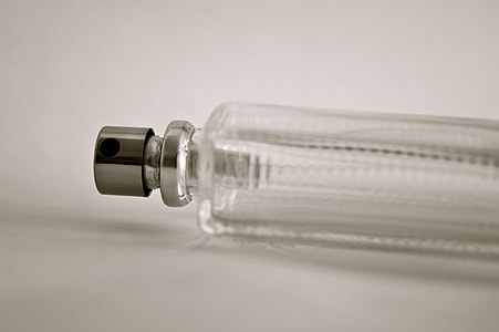 closeup photo of clear glass perfume bottle on white surface thumbnail