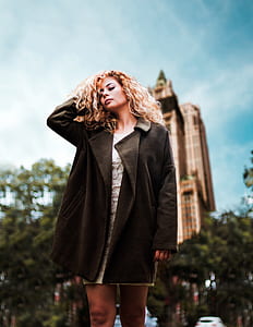 woman in black coat shallow focus photography thumbnail