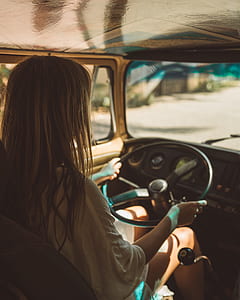 woman driving vehicle during daytime thumbnail