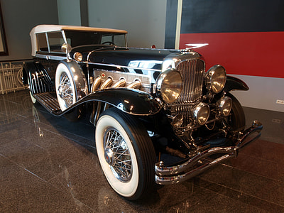 vintage black and white car inside showroom thumbnail