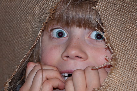 girl hiding on brown textile thumbnail