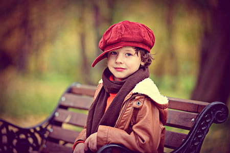 boy wearing red corduroy newsboy cap and brown parka coat thumbnail