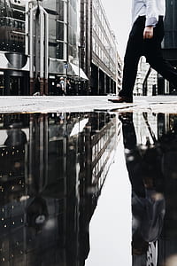 man walking on street near buildings during daytime thumbnail